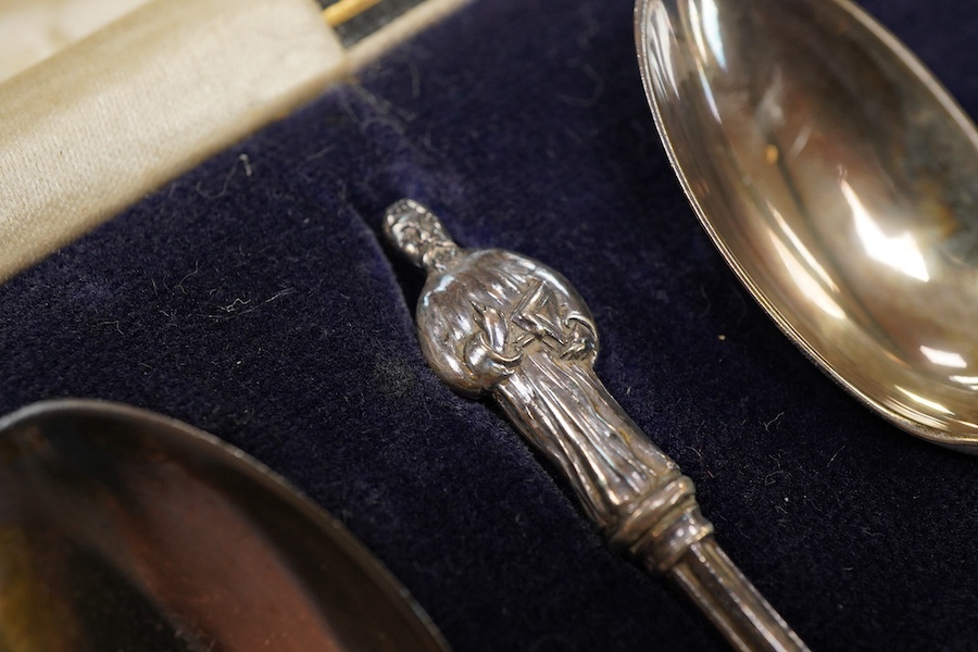 Four assorted cased silver sets including two handled christening bowl and spoon, Birmingham, 1934, a similar christening mug, set of six teaspoons with sugar tongs and six George V lobster picks.